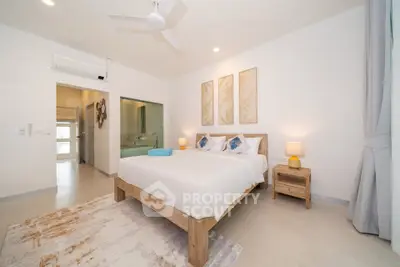 Modern bedroom with stylish decor and ensuite bathroom in a bright, airy apartment.