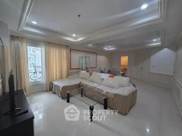 Spacious living room with elegant decor and large windows for natural light.