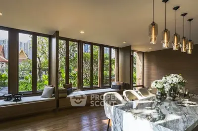 Luxurious living room with floor-to-ceiling windows and elegant marble dining table.