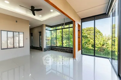 Spacious modern living room with large windows and garden view