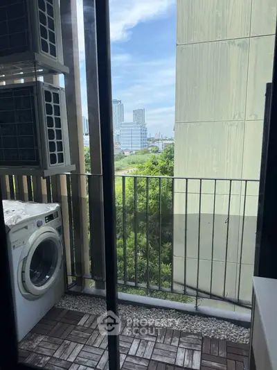 Charming balcony with washer and city view, perfect for urban living.