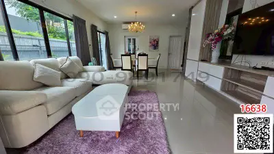 Spacious living room with elegant decor and large windows offering natural light.