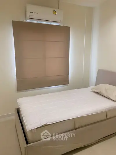 Cozy bedroom with air conditioning and neutral decor, perfect for restful nights.