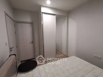 Modern bedroom with sleek wardrobe and minimalist decor