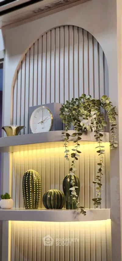 Stylish interior shelf with decorative plants and clock, perfect for modern living room decor.