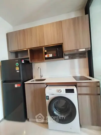 Modern kitchen with sleek appliances and wooden cabinetry
