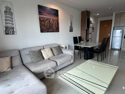 Modern living room with stylish decor, spacious seating, and elegant dining area in a contemporary apartment.
