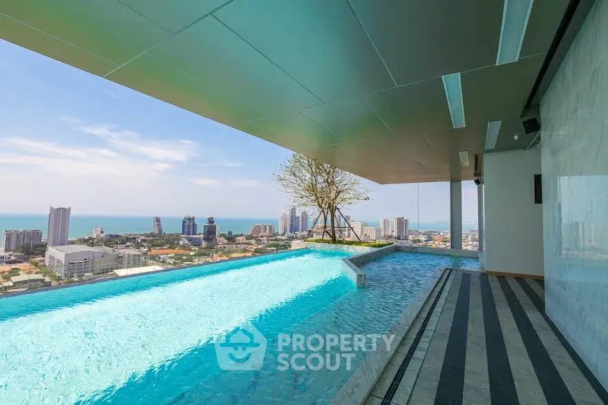 Luxurious rooftop infinity pool with stunning city and ocean views, perfect for relaxation and leisure.
