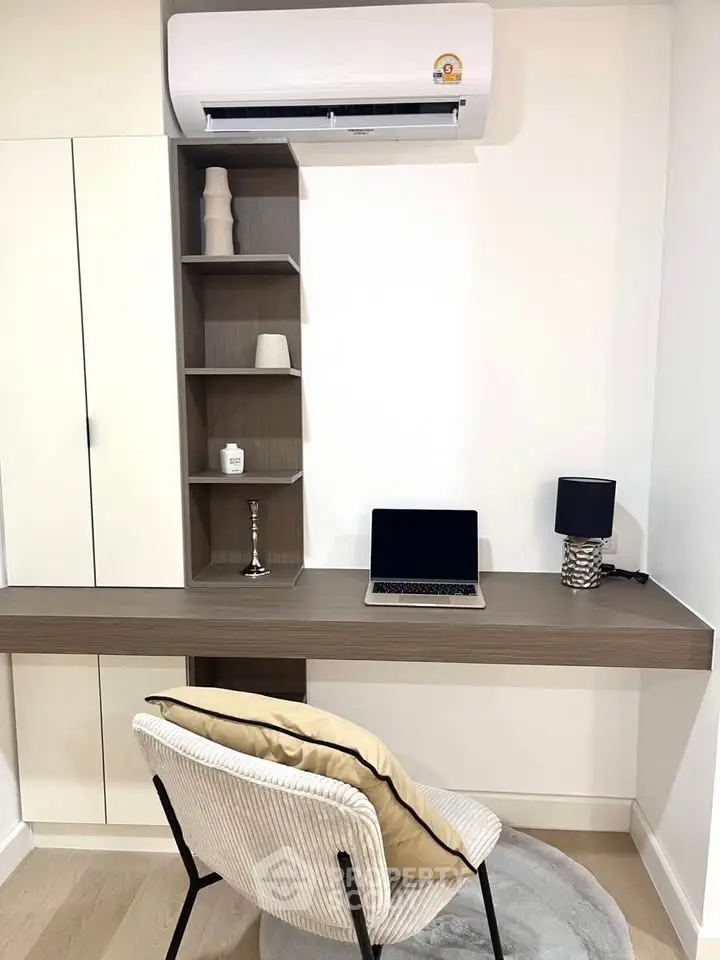 Modern study area with built-in desk, shelves, and air conditioning, perfect for productivity and comfort.