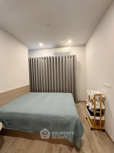 Cozy bedroom with modern decor and soft lighting, featuring a comfortable bed and stylish curtains.