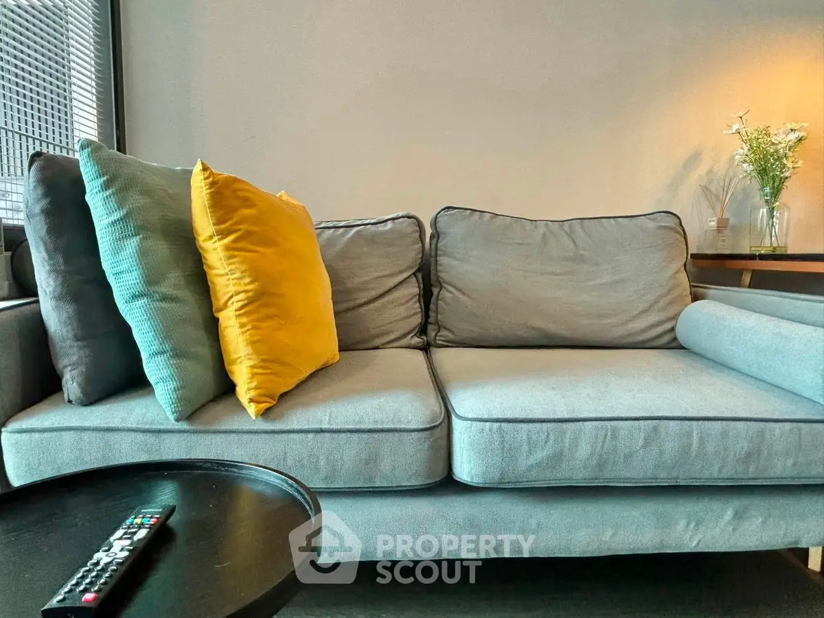 Cozy living room with stylish gray sofa and vibrant cushions, perfect for relaxation and modern living.