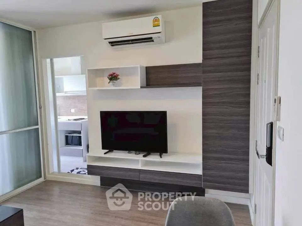 Modern living room with sleek TV unit and air conditioning in stylish apartment.