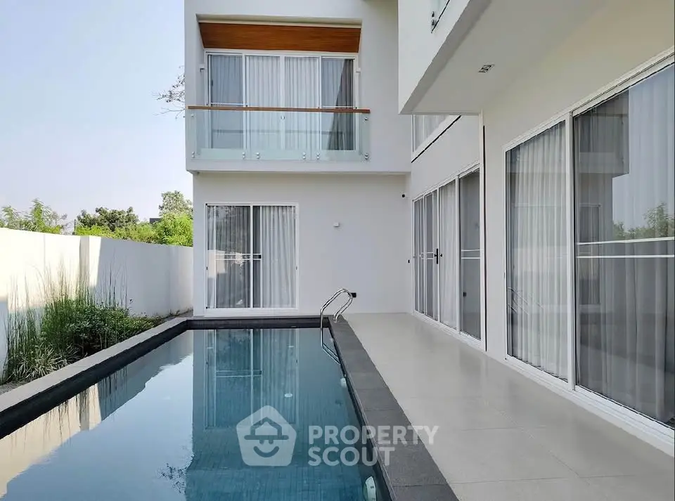 Modern luxury home with sleek pool and spacious balcony, perfect for relaxation and entertainment.