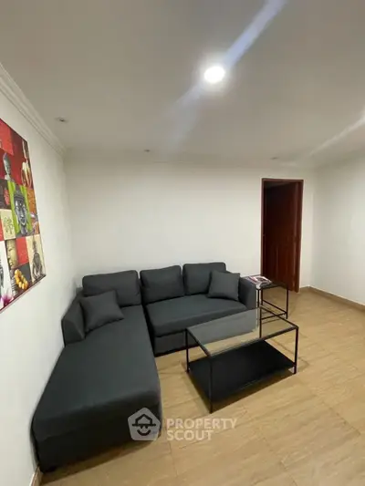 Cozy living room with modern black sofa and minimalist decor