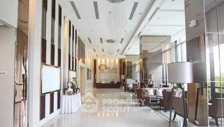 Luxurious modern building lobby with elegant seating and high ceilings, perfect for upscale living.