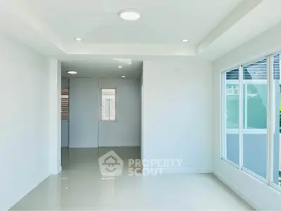 Bright and spacious interior with large windows and modern lighting