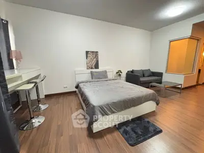 Modern bedroom with sleek furniture and cozy ambiance, perfect for urban living.