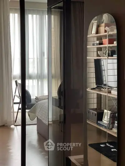 Modern bedroom with sleek mirrored wardrobe and cozy decor
