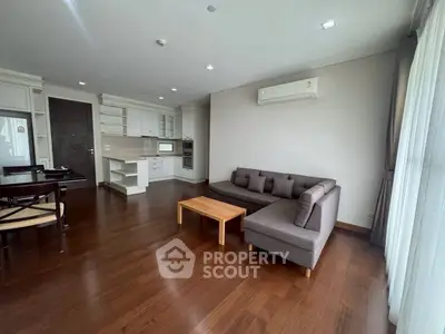 Spacious living room with modern kitchen and wooden flooring