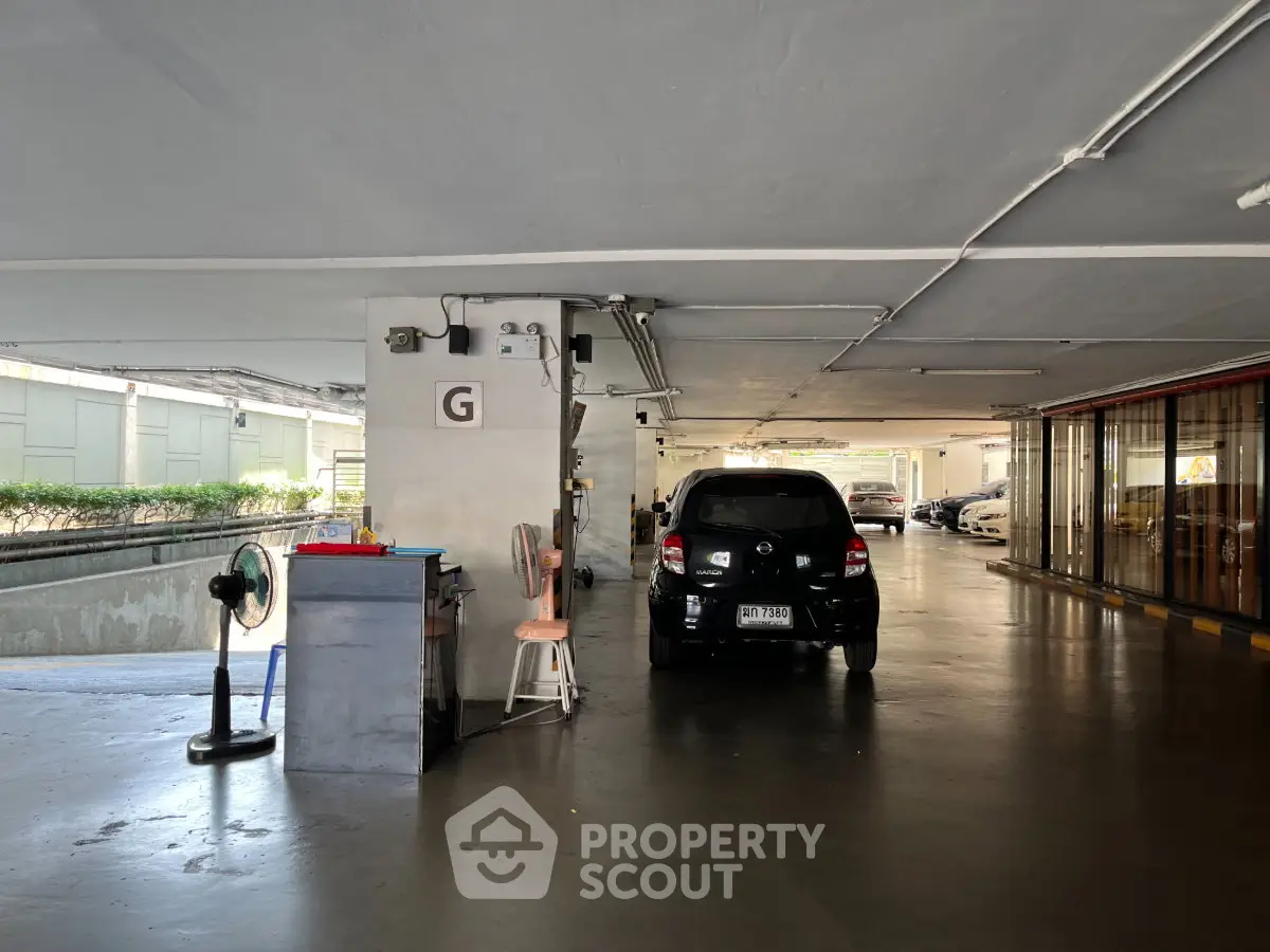 Spacious parking area in a modern building with ample lighting and easy access.