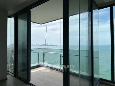 Stunning ocean view from modern glass balcony in high-rise apartment