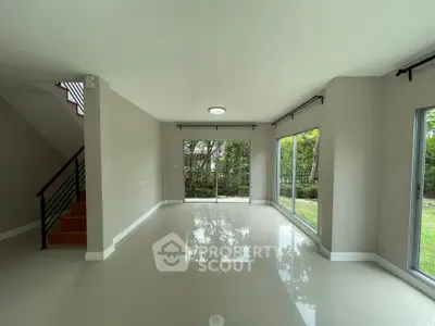 Spacious modern living room with large windows and garden view