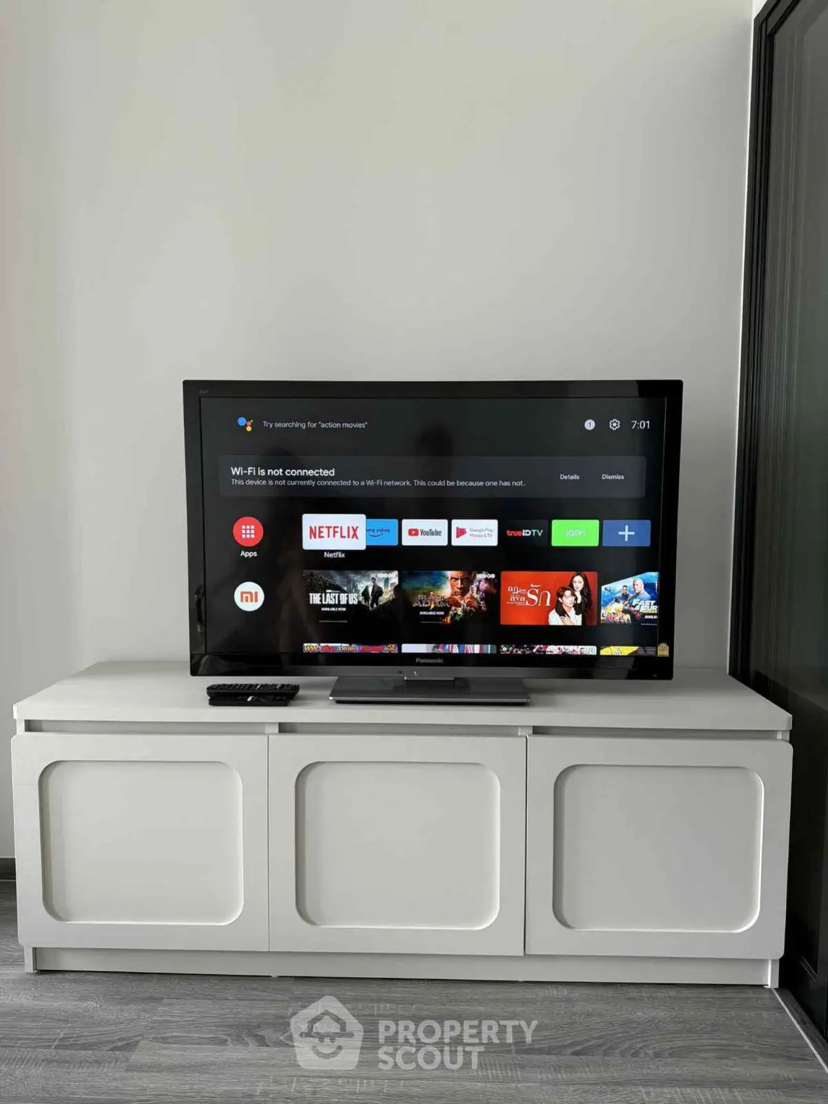 Modern living room with sleek TV setup and stylish cabinet