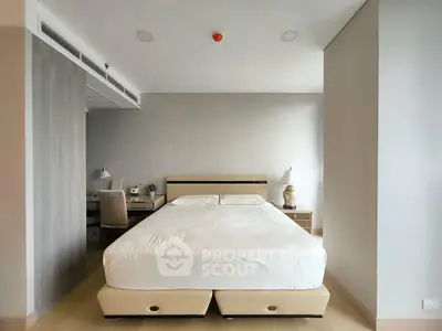 Spacious modern bedroom with elegant decor and natural lighting