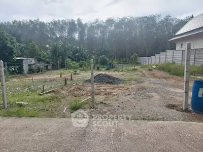 Spacious vacant land plot surrounded by lush greenery, ideal for development opportunities.