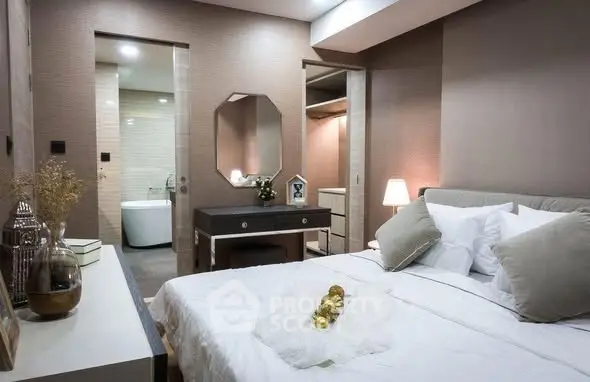 Luxurious bedroom with ensuite bathroom and walk-in closet, featuring elegant decor and ambient lighting.