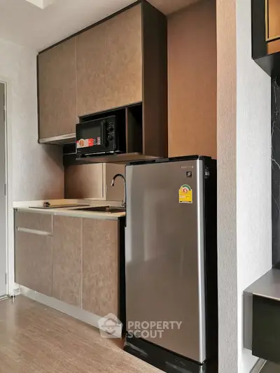 Modern compact kitchen with sleek cabinetry and stainless steel appliances