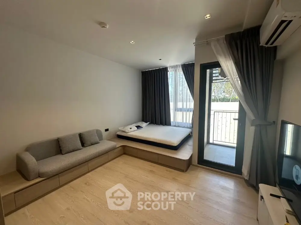 Modern studio apartment with balcony and minimalist decor
