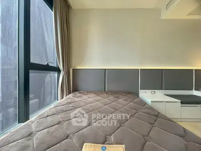 Modern bedroom with large window and stylish decor in a contemporary apartment