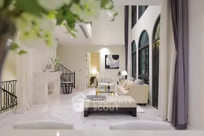 Luxurious living room with high ceilings and elegant decor in a modern apartment.