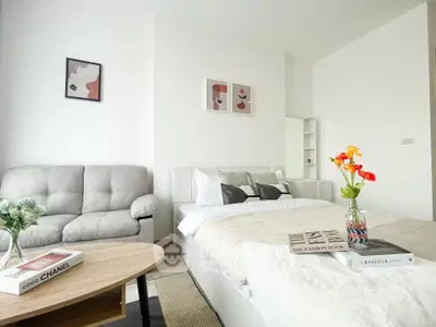 Modern studio apartment with cozy living area and stylish decor