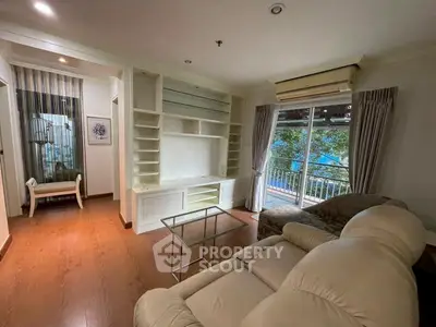 Spacious living room with balcony and modern furnishings in a stylish apartment.