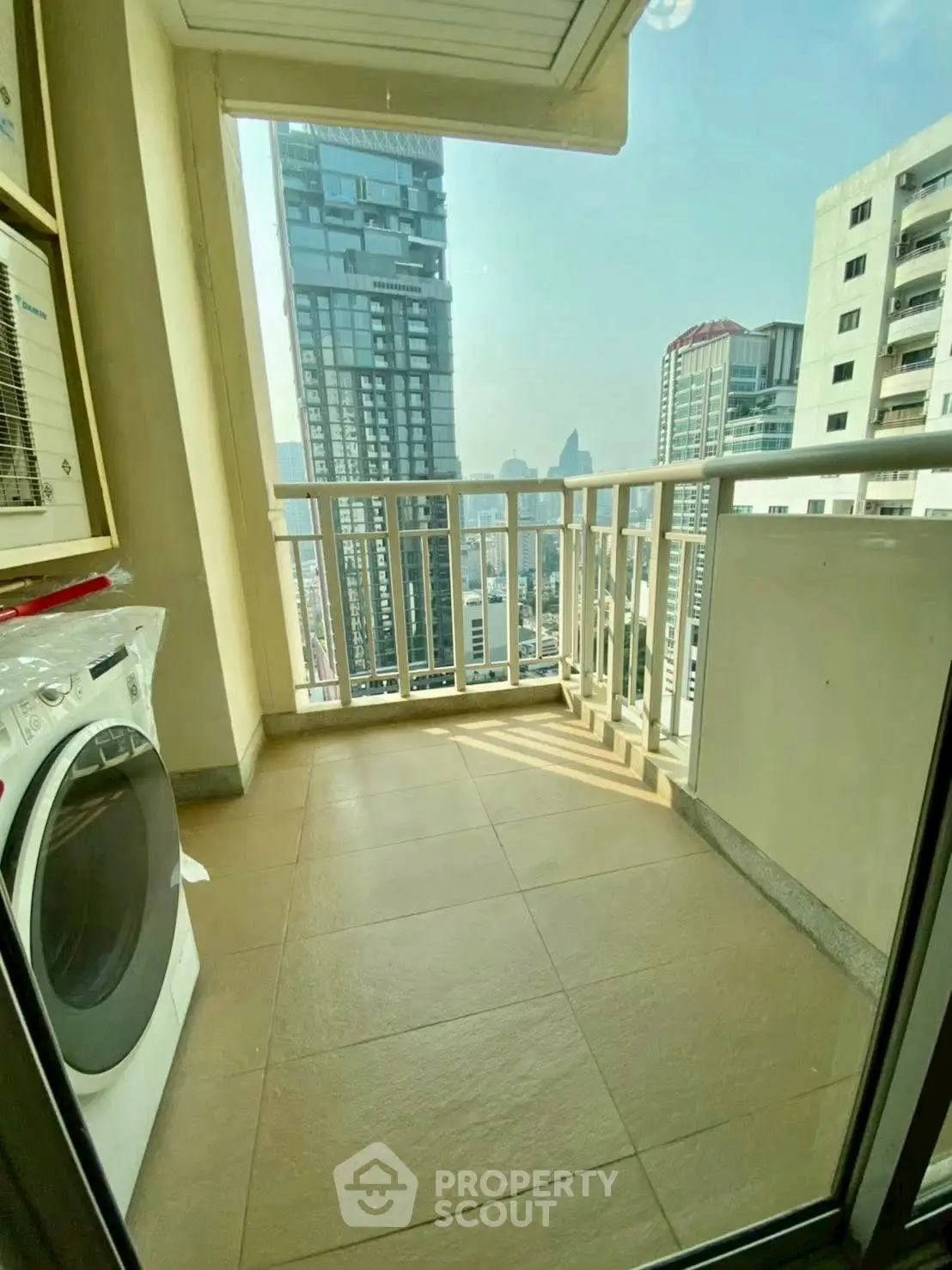 Charming balcony with city view and washing machine, perfect for urban living.