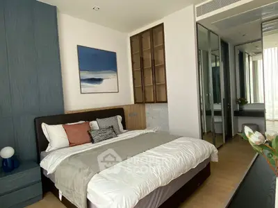 Luxurious bedroom with modern decor and ample natural light, featuring a stylish bed and elegant furnishings.