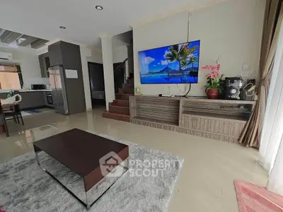 Spacious living room with modern decor and open kitchen layout