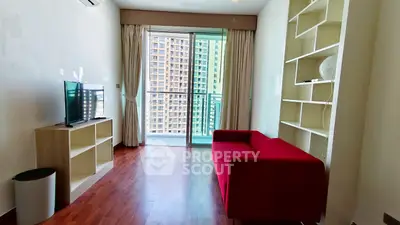 Modern living room with red sofa and balcony view in high-rise apartment