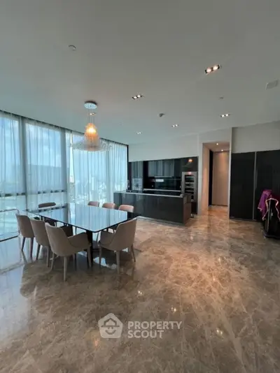 Luxurious open-plan kitchen and dining area with marble flooring and panoramic city views.