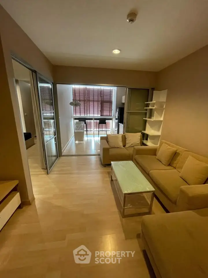 Spacious living room with modern furniture and natural light, perfect for relaxation and entertainment.