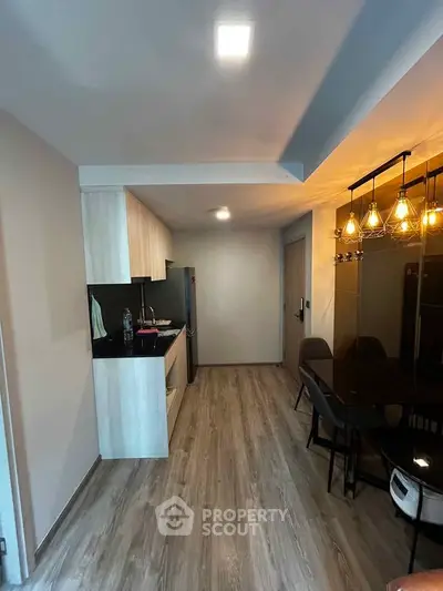 Modern kitchen with sleek design, featuring open layout and stylish lighting, perfect for contemporary living.