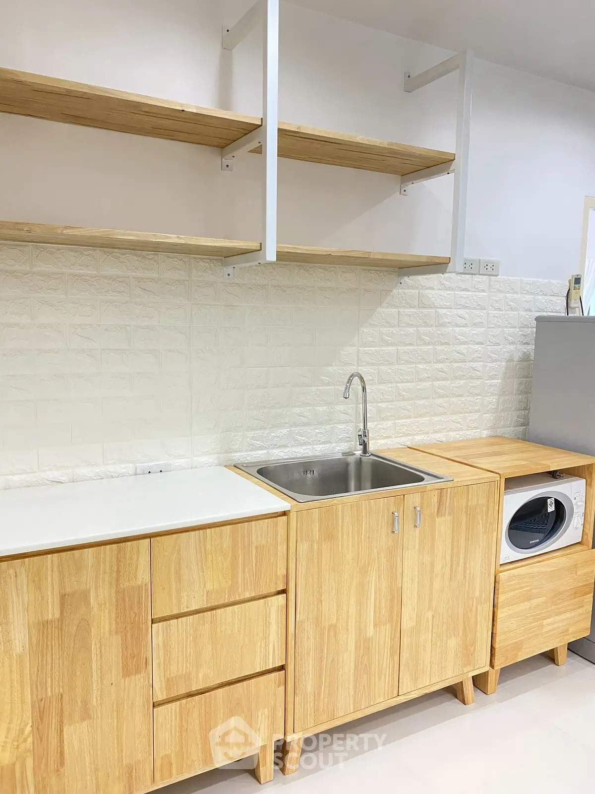 Modern kitchen with wooden cabinets and built-in washing machine