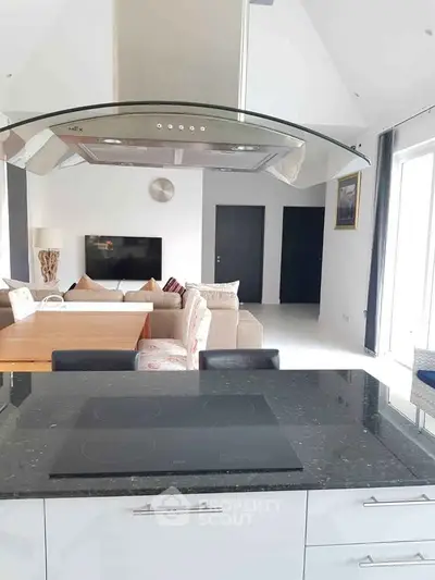 Modern open-plan kitchen and living room with sleek design and natural light