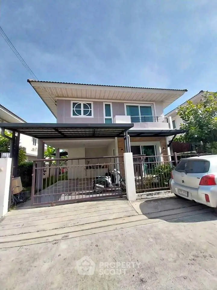 Modern two-story house with carport and driveway in sunny suburban neighborhood.
