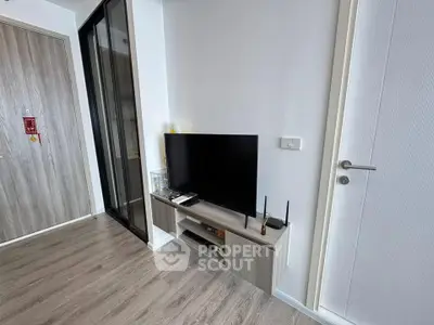 Modern living room with sleek TV stand and wooden flooring