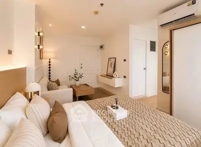 Spacious modern bedroom with elegant decor and cozy seating area