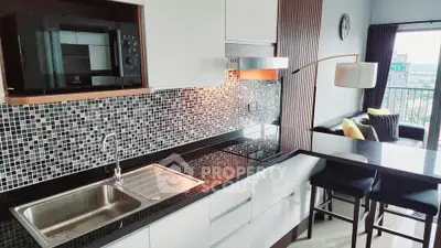 Modern kitchen with sleek black countertops and mosaic backsplash in stylish apartment
