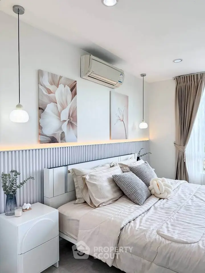 Elegant bedroom with modern decor, featuring cozy bedding and stylish lighting, perfect for relaxation.